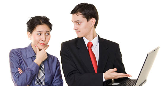 business man and woman looking at a laptop