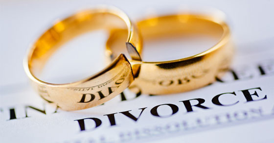 broken wedding rings on divorce papers