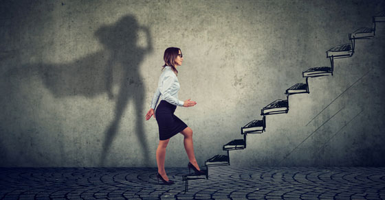 woman walking up stairs with shadow of superhero in background