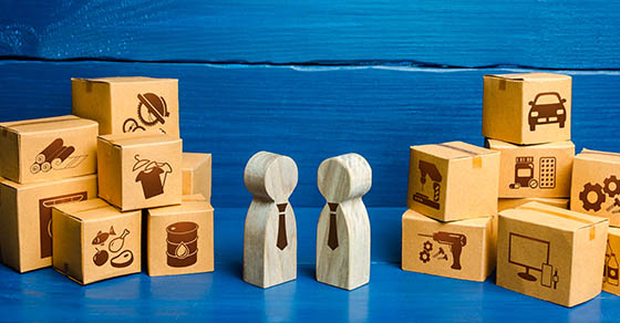 wooden people between two piles of blocks