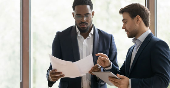 two men looking at piece of paper