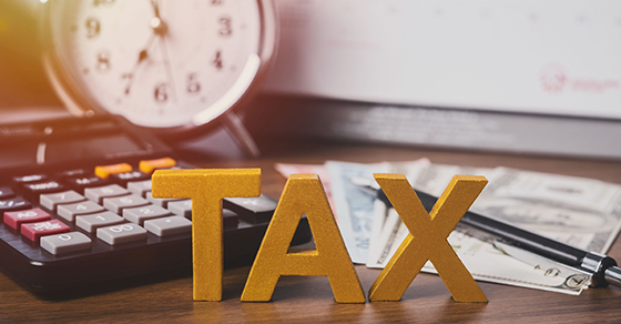 letter blocks spelling out tax on desk