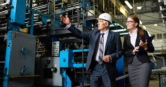 man and woman touring a warehouse