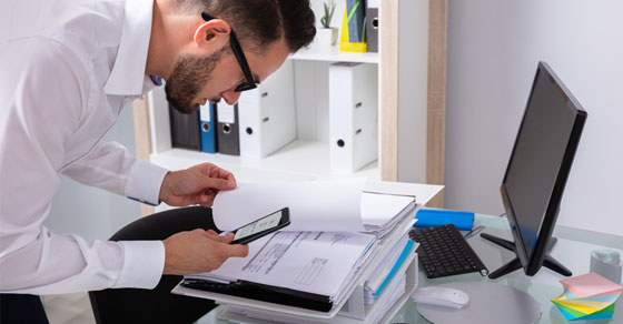 business man taking photo of document with phone