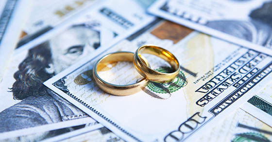 wedding rings on pile of money