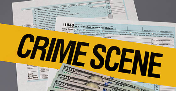 yellow crime scene tape over tax paperwork and money