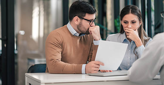 professional man and women looking at a sheet of paper