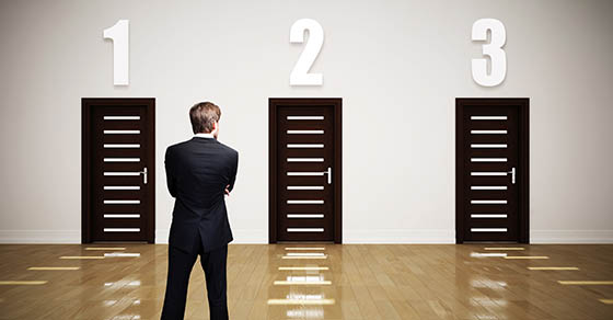 man standing in front of three doors