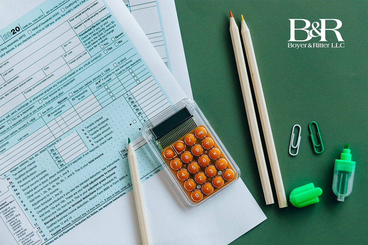 pen and papers and calculator on green table 