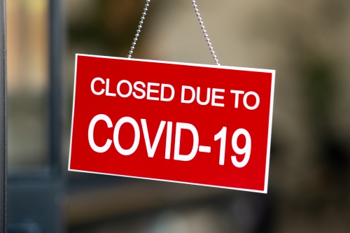 image of closed sign hanging on business door