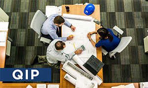 image of people sitting around table with papers