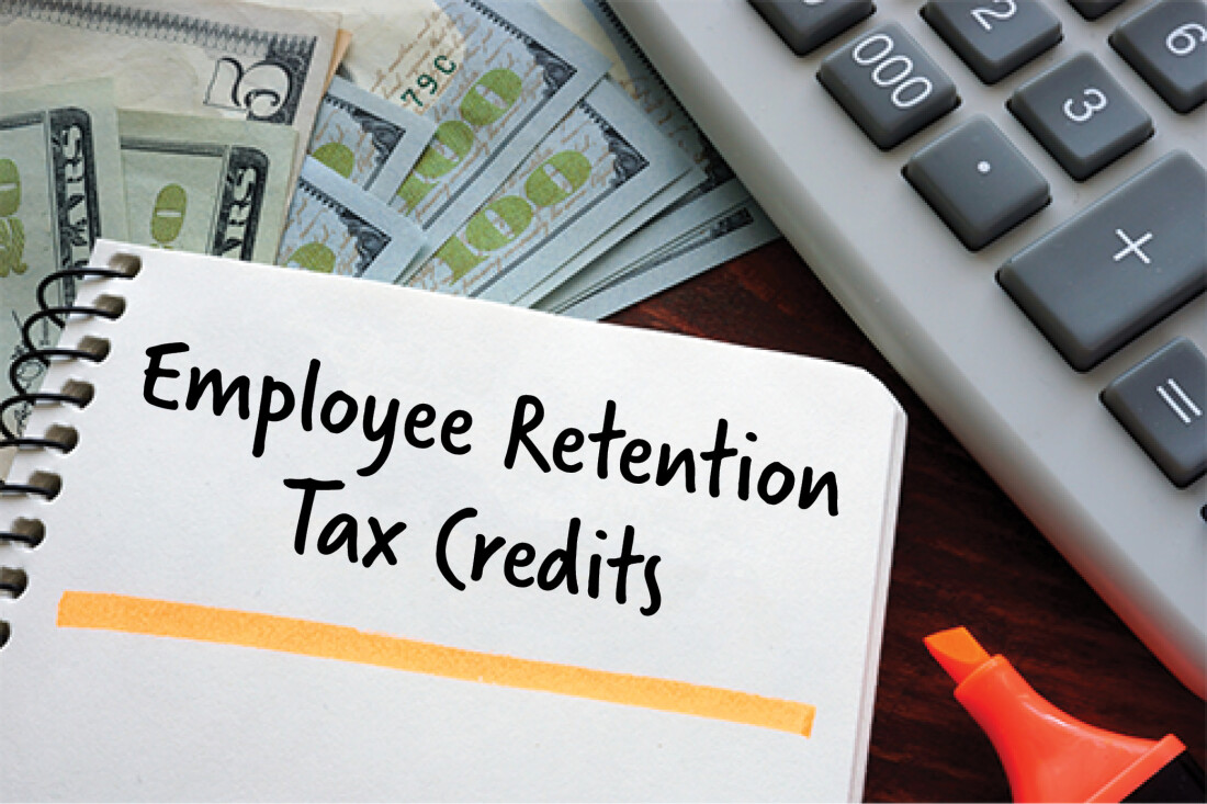 image of calculator, cash, and notebook with text: employee retention tax credits