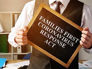 image of man holding chalkboard with text - families first coronavirus response act