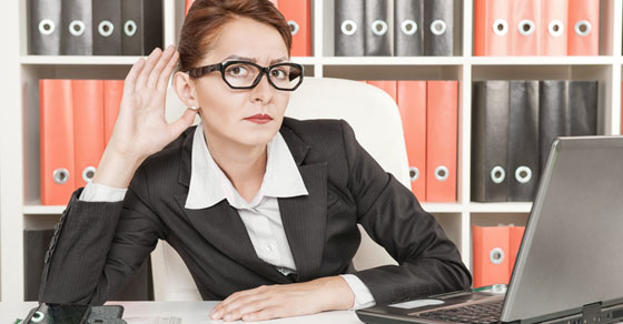 image of business woman with hand to her ear
