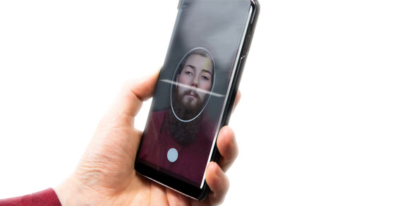 image of man looking into iphone