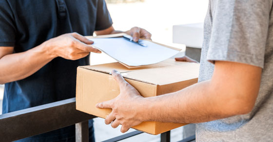 image of man signing for package