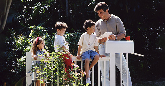 father with children by mailbox