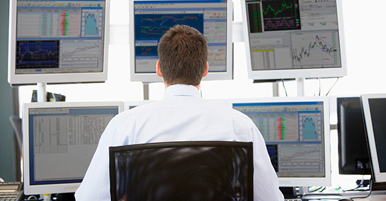 image of man facing multiple computer screens