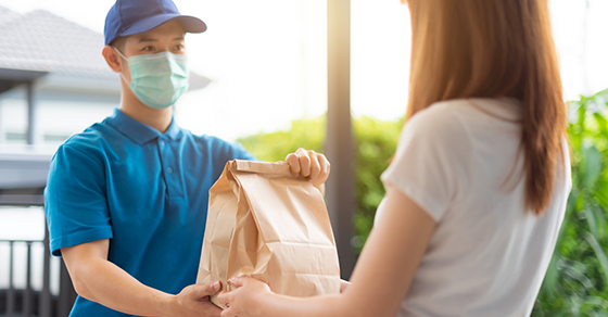 image of man handing delivery to woman