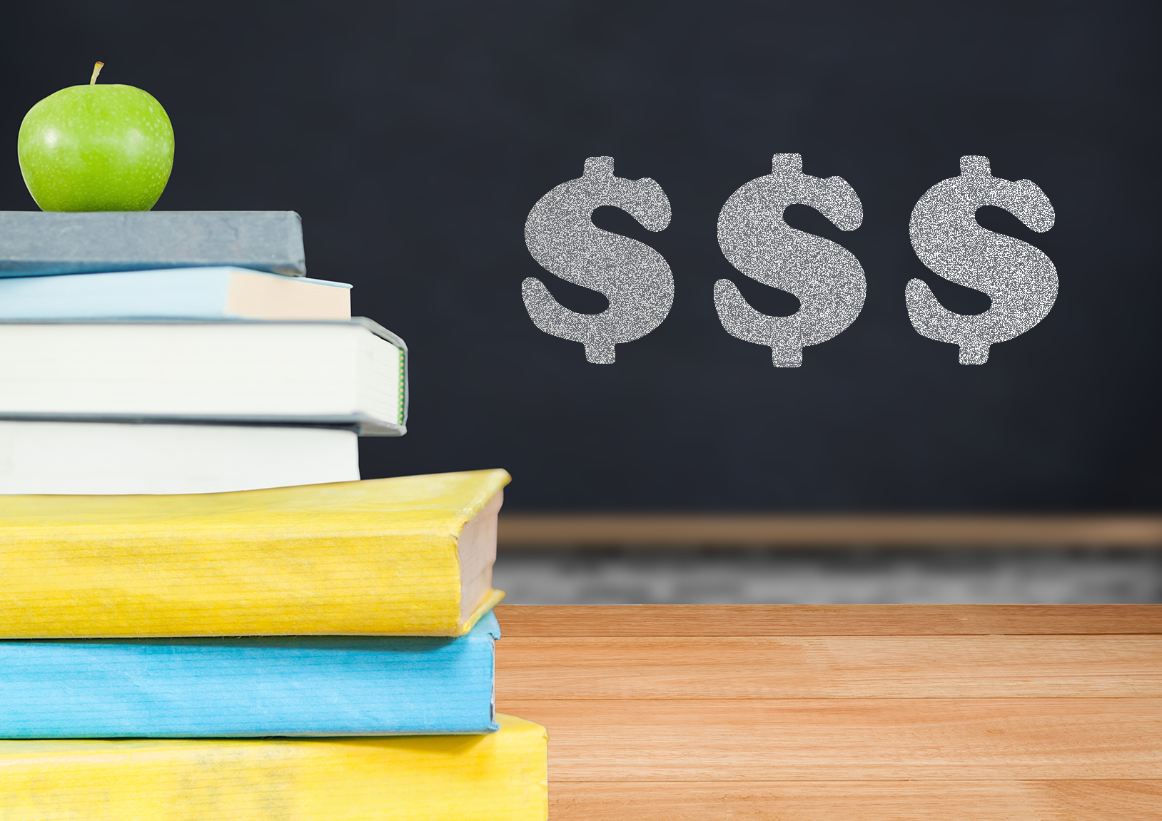 apple sitting on stack of books